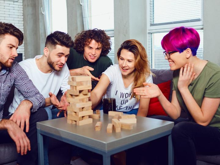 Group of teens playing Jenga together