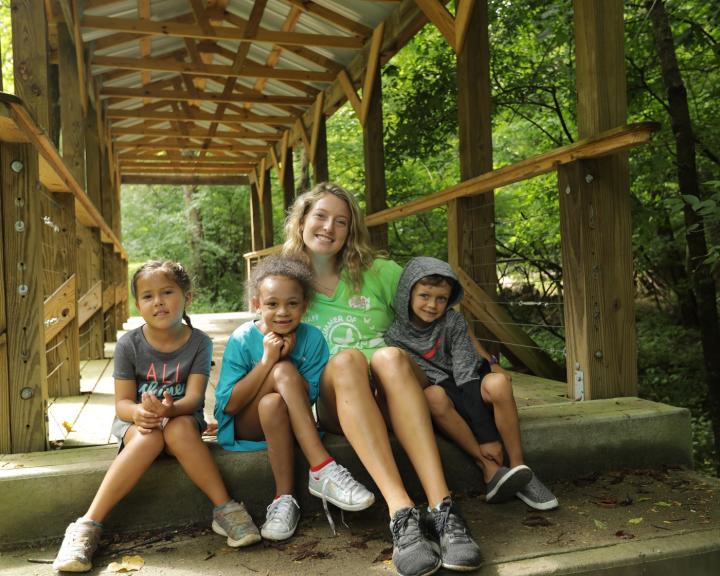 YMCA Louisville staff poses with children outdoors