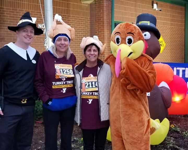 YMCA Louisville Turkey Trot runners posing with people dressed as a pilgrim and turkey YMCA Louisville Turkey Trot runners posing with people dressed as a pilgrim and turkey