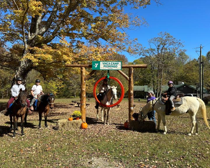 Group of horseback riders at the Camp Piomingo entrance