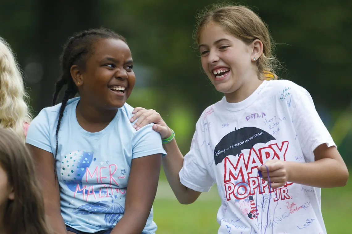 Kids laughing outside at YMCA youth mentoring program
