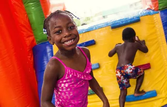 Girl and boy playing in a bounce house