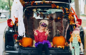 Girl in costume trunk or treating