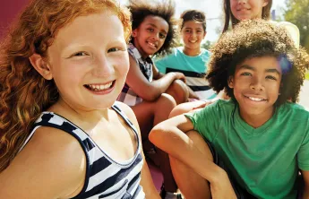 Group of kids sitting outside