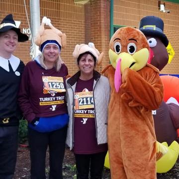 YMCA Louisville Turkey Trot runners posing with people dressed as a pilgrim and turkey YMCA Louisville Turkey Trot runners posing with people dressed as a pilgrim and turkey