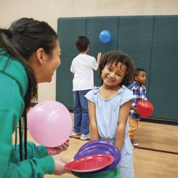 YMCA teen playing with little girl after school YMCA teen playing with little girl after school