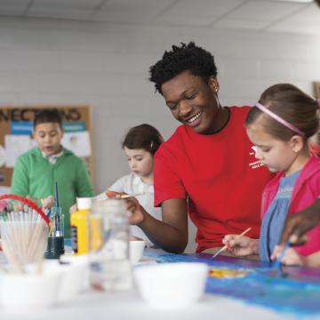 YMCA children laughing together while painting YMCA children laughing together while painting