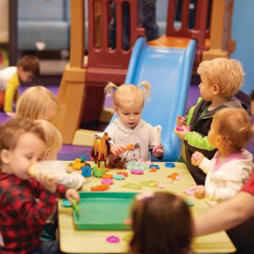YMCA staff crafting with kids during child care program YMCA staff crafting with kids during child care program