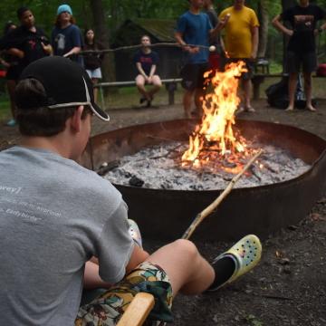 Camper roasts smores over the fire pit at YMCA Camp Piomingo Camper roasts smores over the fire pit at YMCA Camp Piomingo