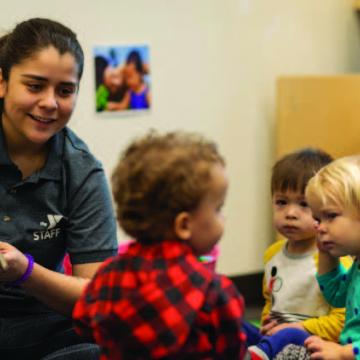YMCA staff reading to children during child care program YMCA staff reading to children during child care program