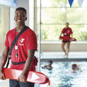 Two lifeguards and children swimming at YMCA swimming pool Two lifeguards and children swimming at YMCA swimming pool