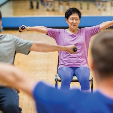 Adults lifting dumbbells at YMCA Louisville forever young fitness class Adults lifting dumbbells at YMCA Louisville forever young fitness class