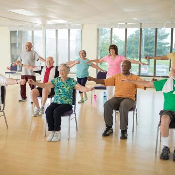 Group of older adults doing arm exercises at YMCA Louisville Forever Young fitness class Group of older adults doing arm exercises at YMCA Louisville Forever Young fitness class
