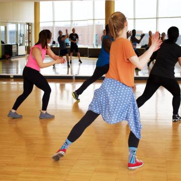 Adults dancing and clapping at group dance class Adults dancing and clapping at group dance class