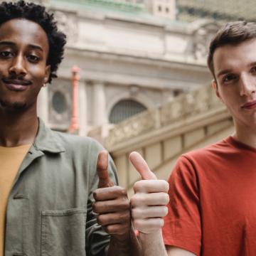 Two teens giving a thumbs up Two teens giving a thumbs up