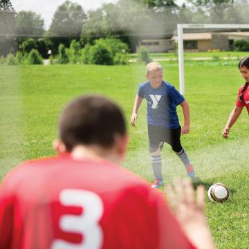 Kids playing in youth soccer league game Kids playing in youth soccer league game