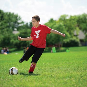 Kids playing in youth soccer league game Kids playing in youth soccer league game