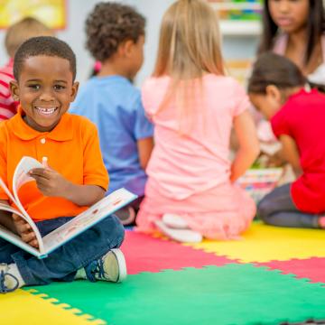 Child reading book at YMCA child development center Child reading book at YMCA child development center