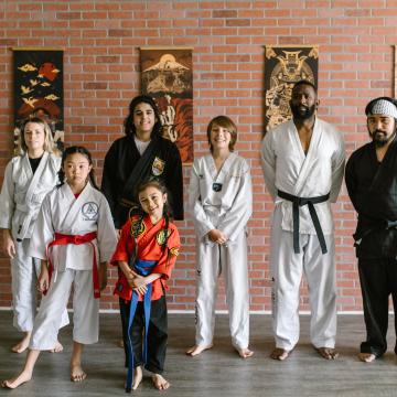Martial arts teachers and students smiling for the camera Martial arts teachers and students smiling for the camera