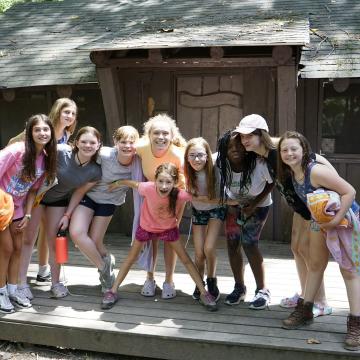 Group of campers standing together outside of their cabin at YMCA Camp Piomingo Group of campers standing together outside of their cabin at YMCA Camp Piomingo