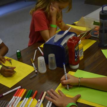 Campers writing letters and doing crafts Campers writing letters and doing crafts