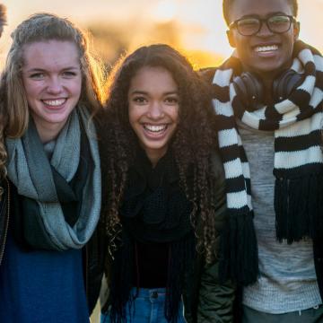 Group of teens standing outside together in the fall Group of teens standing outside together in the fall