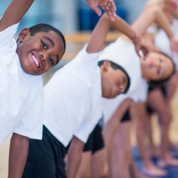 Group of kids stretching before participating in sports Group of kids stretching before participating in sports