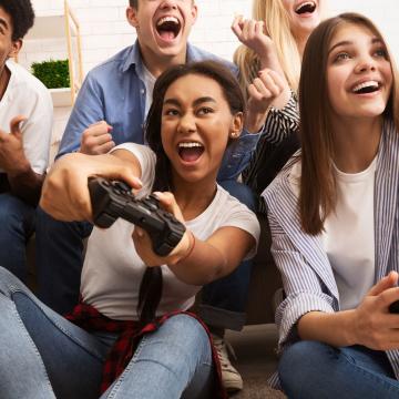 Group of teens playing video games together Group of teens playing video games together