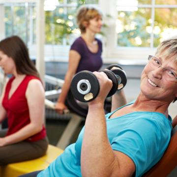Women of various ages in the gym lifting weights Women of various ages in the gym lifting weights
