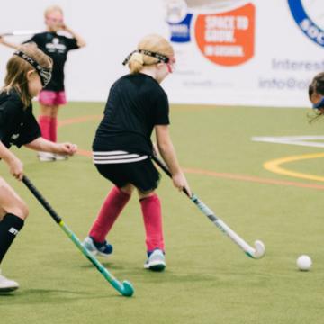 Group of kids learning how to play field hockey Group of kids learning how to play field hockey