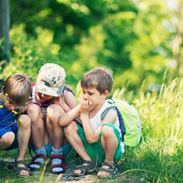 Group of kids outside exploring nature Group of kids outside exploring nature
