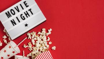 Movie night sign with popcorn and drink cups with straws